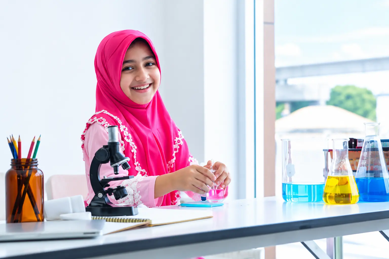Smiling Young Scientist in Pink Hijab - Canadian Curriculum